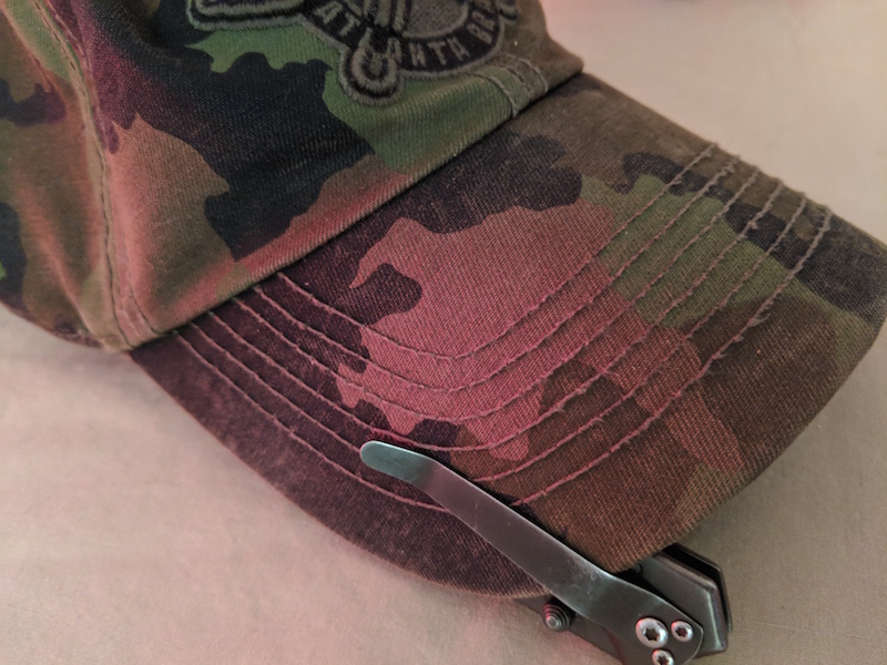 edc knife clipped to edc hat bill